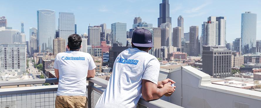 Male students looking out over the city of Chicago