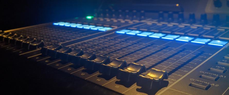 A Yamaha CL5 mixer's fader bank photographed on an oblique angle
